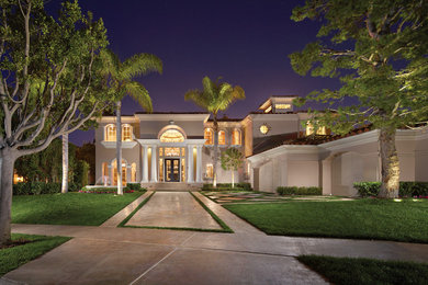 Example of a classic beige two-story exterior home design in Orange County