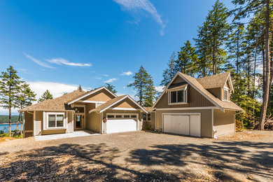 Arts and crafts beige two-story vinyl exterior home photo in Vancouver with a shingle roof