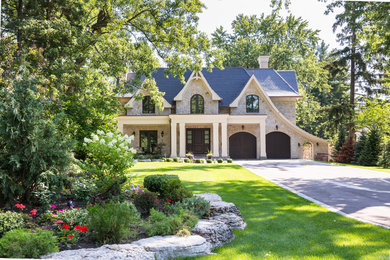 Inspiration for a large timeless two-story stone exterior home remodel in Toronto