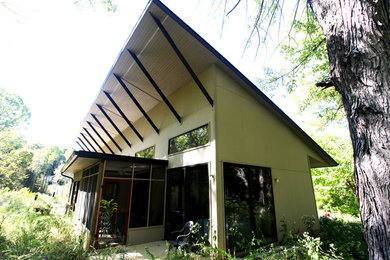 Large contemporary beige two-story wood house exterior idea in Indianapolis with a shed roof