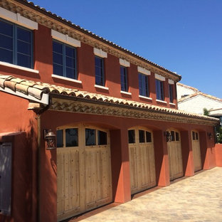 This is an example of a large two-storey beige house exterior in San Francisco with stone veneer, a gable roof and a tile roof.