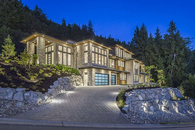 Huge minimalist beige three-story stone house exterior photo in Vancouver with a hip roof and a metal roof