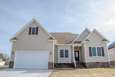 Inspiration for a mid-sized transitional beige one-story vinyl house exterior remodel in Richmond with a hip roof and a shingle roof