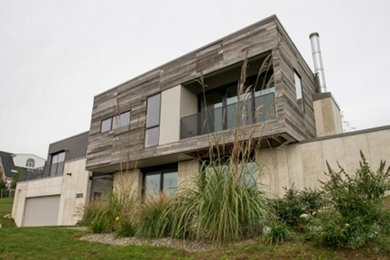 Large trendy gray two-story mixed siding flat roof photo in Philadelphia