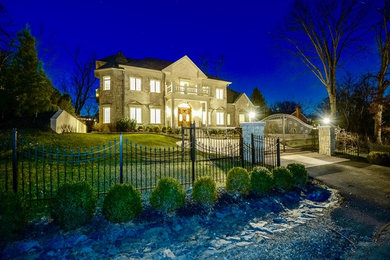 Inspiration for a huge timeless beige three-story stone exterior home remodel in DC Metro