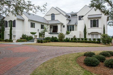 Example of a large transitional white two-story stucco exterior home design in Atlanta with a tile roof