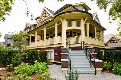 Mid-sized victorian one-story wood house exterior idea in Vancouver with a hip roof and a shingle roof