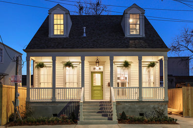 Mid-sized traditional beige two-story concrete fiberboard gable roof idea in New Orleans