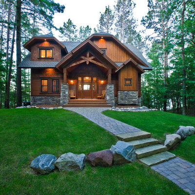 Example of a mid-sized mountain style brown two-story wood exterior home design in Minneapolis with a clipped gable roof