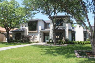 Beige classic two floor house exterior in Dallas with a shingle roof.
