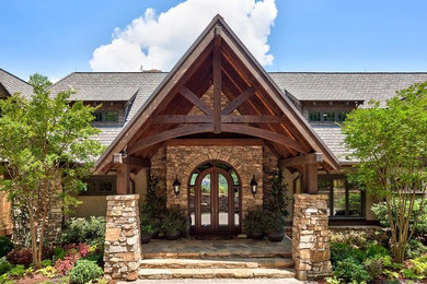 Example of a large mountain style beige two-story mixed siding exterior home design in Charlotte with a shingle roof