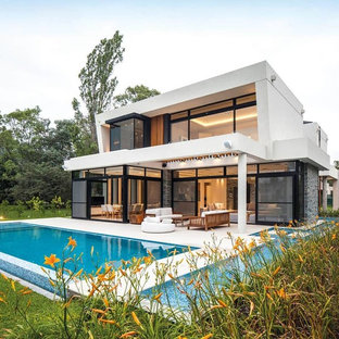 Example of a large minimalist two-story mixed siding house exterior design in Los Angeles with a hip roof