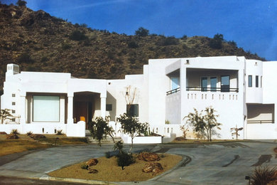 Example of a large trendy white stucco flat roof design in Phoenix