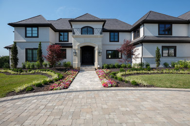 Example of a huge transitional mixed siding house exterior design in Kansas City with a tile roof
