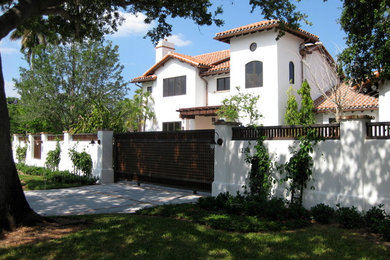 Large tuscan white two-story stucco exterior home photo in Other with a hip roof