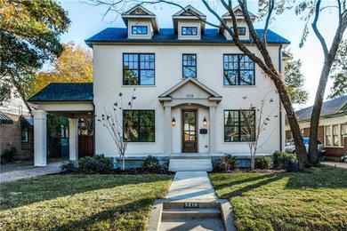 Example of a large classic beige two-story brick exterior home design in Dallas with a shingle roof