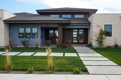 Example of a large trendy gray one-story mixed siding exterior home design in Boise with a hip roof