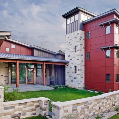 Example of a large trendy red two-story metal house exterior design in Austin with a shed roof and a metal roof