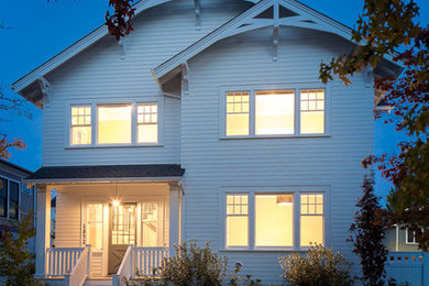 Example of a large classic white three-story wood exterior home design in Seattle