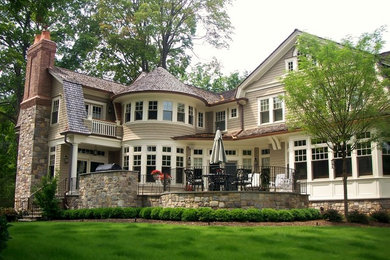 Large traditional gray three-story wood exterior home idea in New York