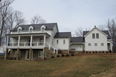 Example of a mid-sized farmhouse white two-story concrete fiberboard gable roof design in Other