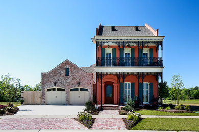 Elegant red two-story mixed siding exterior home photo in New Orleans