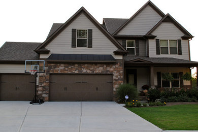 Example of a mid-sized arts and crafts brown two-story mixed siding exterior home design in Atlanta with a shingle roof