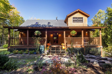 Mid-sized mountain style brown two-story wood exterior home photo in Boston with a shingle roof
