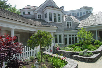 Example of a large beach style gray two-story wood exterior home design in Portland Maine with a gambrel roof