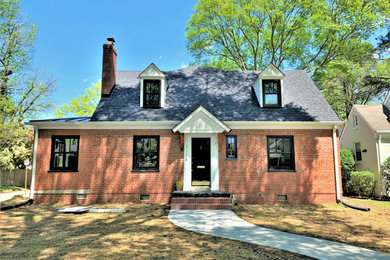 Inspiration for a mid-sized timeless orange two-story brick exterior home remodel in Richmond with a shingle roof