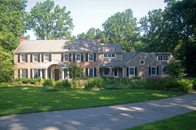Mid-sized elegant beige two-story brick exterior home photo in Philadelphia