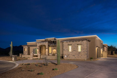 Large southwestern beige one-story concrete exterior home idea in Phoenix