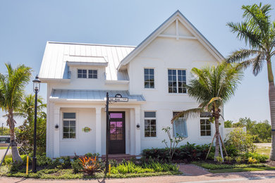Inspiration for a coastal white two-story house exterior remodel in Miami with a metal roof