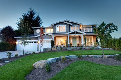 Large elegant gray two-story wood house exterior photo in Vancouver with a hip roof and a shingle roof
