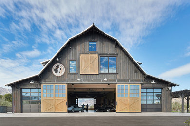 Large country brown two-story wood exterior home idea in Seattle with a gambrel roof and a metal roof