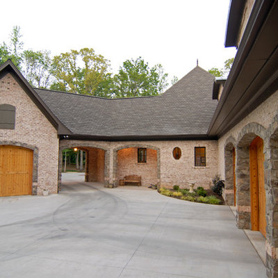 Mid-sized elegant beige two-story mixed siding exterior home photo in Charlotte with a hip roof