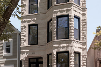 Large transitional gray three-story stone flat roof photo in Chicago