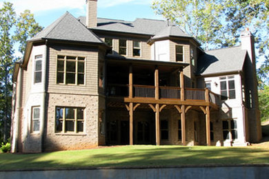 Large transitional gray three-story mixed siding exterior home photo in Atlanta with a hip roof