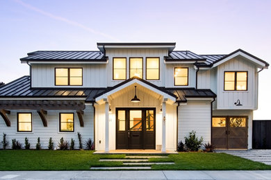 Transitional white two-story wood house exterior photo in San Francisco with a metal roof