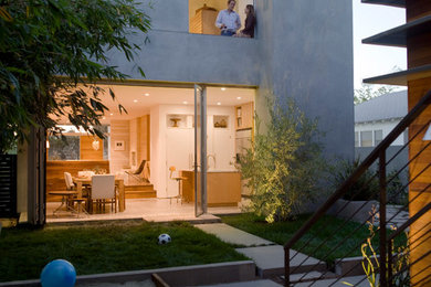 Mid-sized minimalist gray two-story stucco exterior home photo in Los Angeles