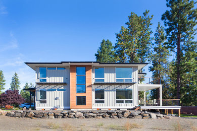Inspiration for a mid-sized contemporary gray two-story mixed siding house exterior remodel in Seattle with a hip roof