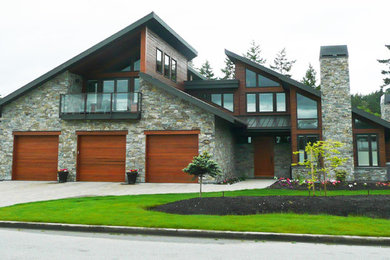 Example of a trendy house exterior design in Vancouver with a metal roof