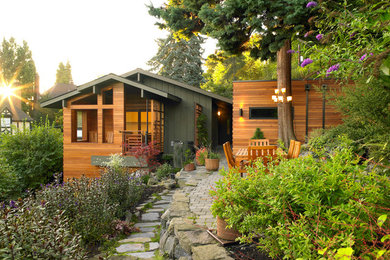 Diseño de fachada de casa multicolor vintage con revestimiento de madera y tejado a dos aguas
