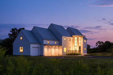 Large trendy white two-story concrete fiberboard gable roof photo in Portland Maine