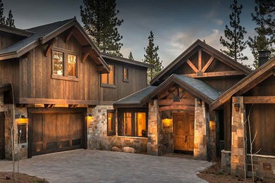 Large rustic brown two-story wood exterior home idea in Other with a shingle roof