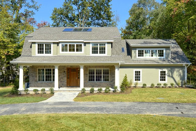 Inspiration for a large craftsman green two-story wood exterior home remodel in Baltimore with a shingle roof