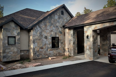 Example of a mid-sized classic gray one-story stone exterior home design in Salt Lake City with a shingle roof