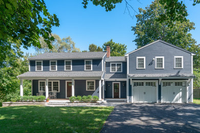Large blue two-story house exterior photo in Boston with a shingle roof