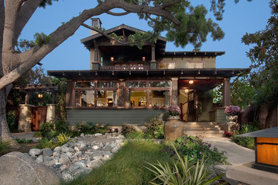 Large arts and crafts green two-story wood exterior home photo in San Diego with a shingle roof