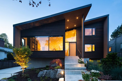 Inspiration for a modern black house exterior remodel in Other with a shed roof